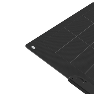 Close-up of the corner of the 400W PRO Solar Blanket with Raptor Skin, showing black monocrystalline cells with grid lines and a metal grommet for mounting against a white background.