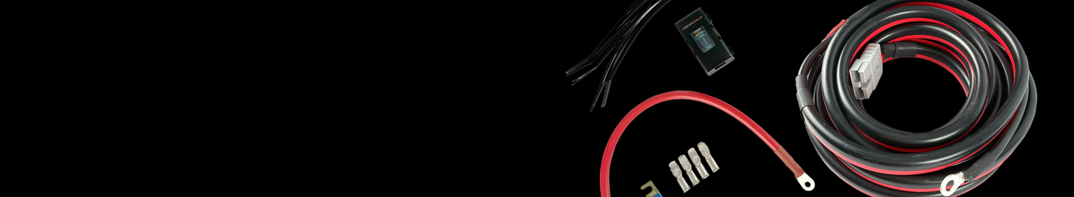A coiled black and red power cable, connectors, fuses, and small black wires are arranged on a black background.