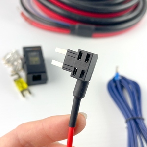 A hand holds a black fuse tap connector; behind it are red/black wires, a blue 6AWG cable, yellow fuse, and black holder—perfect for the iTechworld Plug and Play 40A DCDC Wiring Kit or dual battery systems.