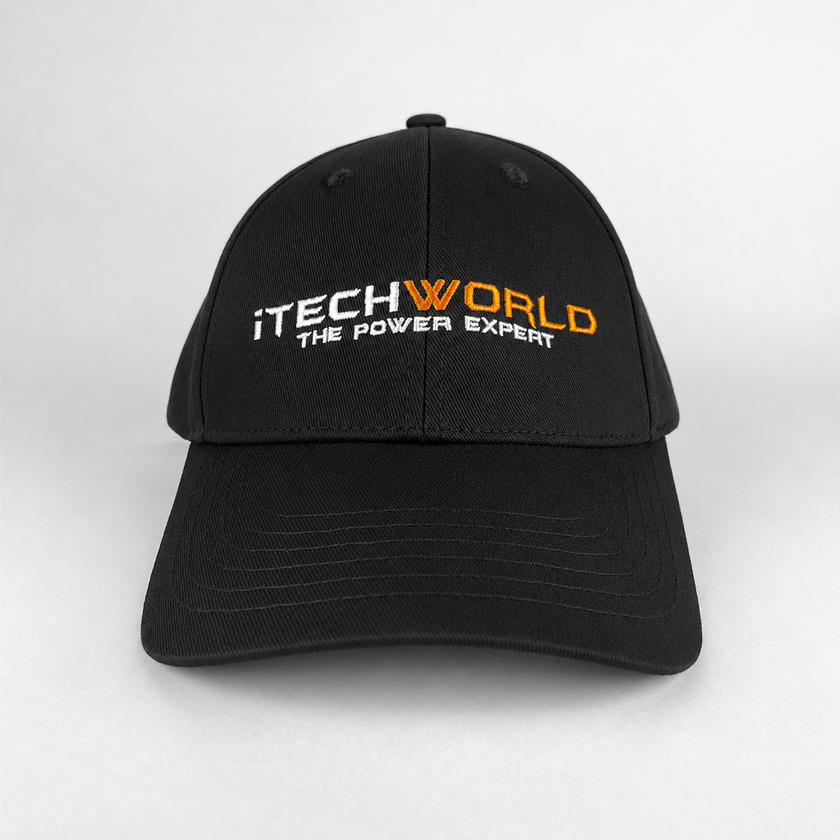 The iTechworld embroidered black cotton baseball cap features "THE POWER EXPERT" in white and orange thread on the front, an adjustable strap for a custom fit, and is shown against a light grey background.