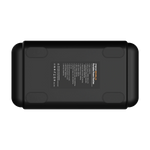 A black rectangular iTechworld 2000W 120AH PS1800 PRO Portable Lithium Power Station with Bluetooth is viewed from the bottom, displaying corner rubber pads and a central label featuring technical information and branding. This robust device combines advanced lithium technology and durable construction, offering convenient portable power for a variety of on-the-go energy needs.