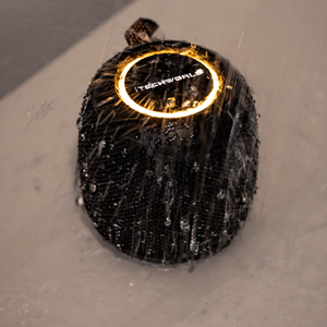 The iTechworld Pulse Mini Waterproof Portable Speaker, shown with a glowing ring light and water splashes, highlights its water-resistant design and high-fidelity audio.