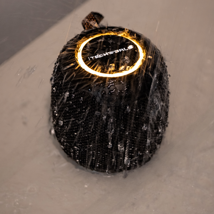 The iTechworld Pulse Mini Waterproof Portable Speaker, shown with a glowing ring light and water splashes, highlights its water-resistant design and high-fidelity audio.