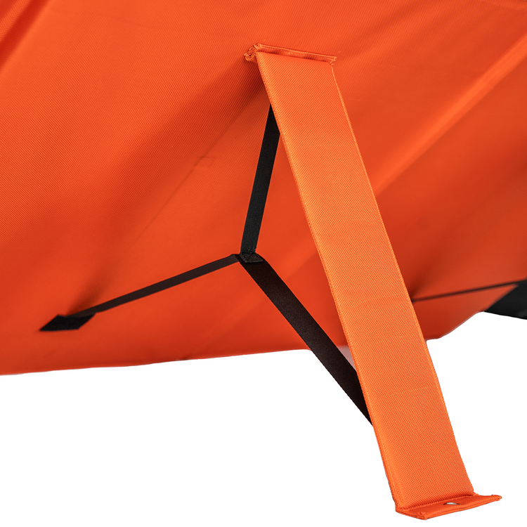 Close-up of an orange fabric structure with sturdy straps, possibly part of a tent or chair, next to the 400W Solar Blanket with Raptor Skin portable solar panel.