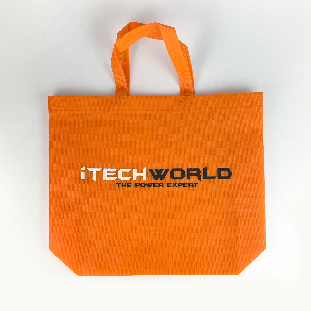 The iTechworld Tote Bag is a bright orange, reusable bag featuring "THE POWER EXPERT" text in black and white, two handles, and a flat bottom. Durable and stylish, this gear bag is shown on a white background.