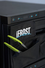 A close-up of a black appliance with a digital display and buttons, showcasing the iTechworld iFROST Draw Fridge Organiser with a labeled FROST pocket holding green-handled tongs.