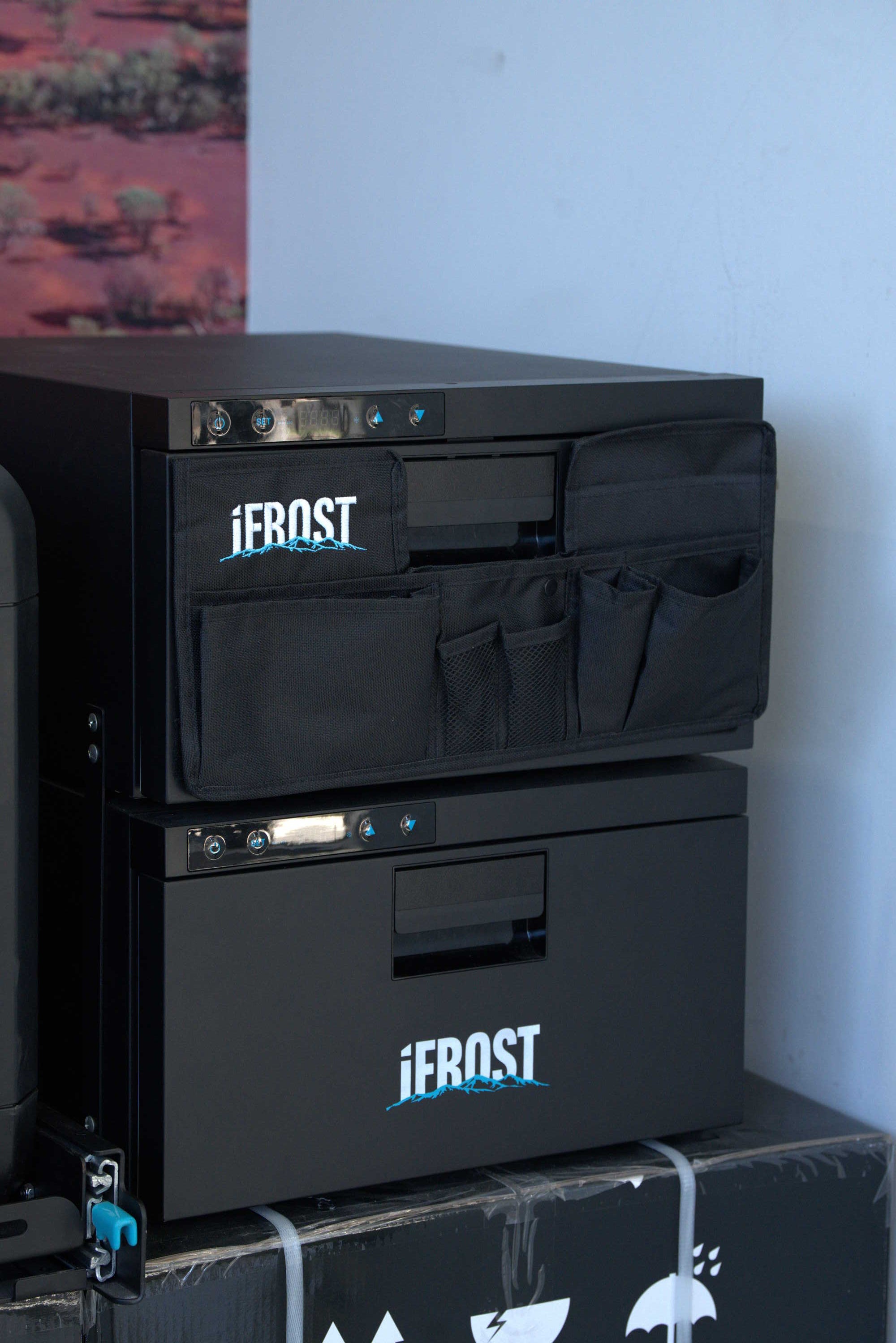 A close-up of a black metal utility cabinet or tool box with the brand name 'iFROST' printed in white on the front, next to a matching black tool bag with the same logo.