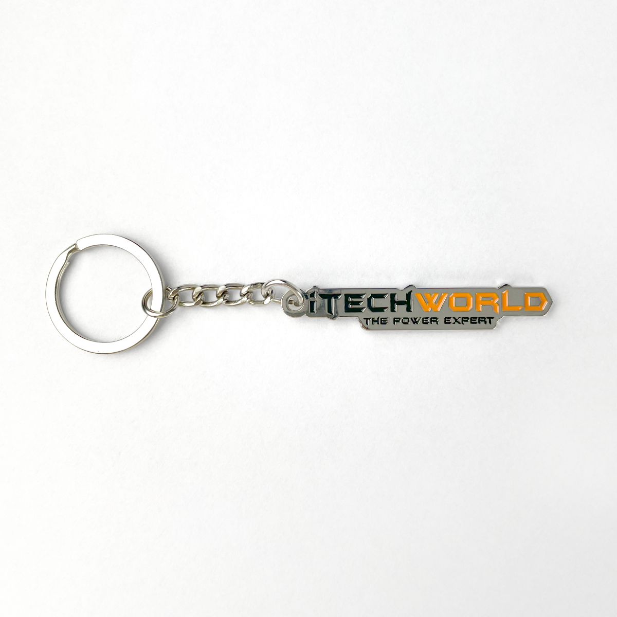 The iTechworld Iron Keyring features a CNC-cut iron rectangular tag with "TECHWORLD THE POWER EXPERT" in black, green, and orange on white, attached to a metal chain and keyring.