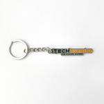 The iTechworld Iron Keyring features a CNC-cut iron rectangular tag with "TECHWORLD THE POWER EXPERT" in black, green, and orange on white, attached to a metal chain and keyring.