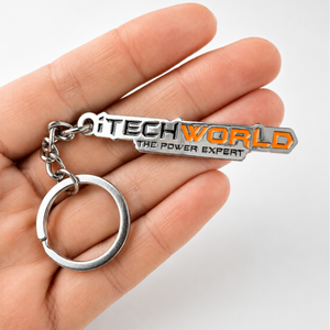 A hand holds an iTechworld iron keyring with laser-etched branding in black and orange, attached to a silver keyring.